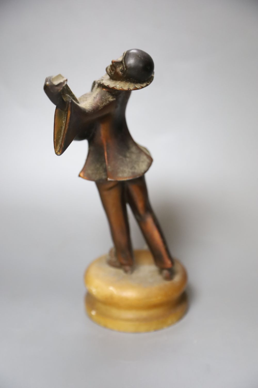 A 1930s Pierrot musician playing the lute, on alabaster plinth, height 23cm